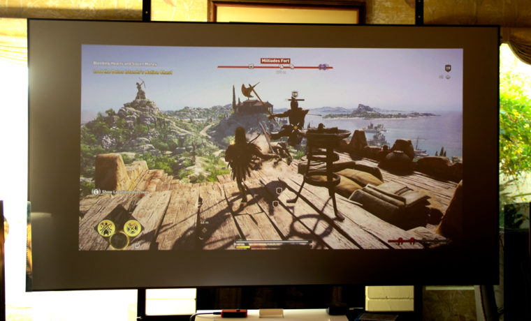 The LG HU85LA projecting Assassin's Creed Odyssey via the Playstation 4 Pro, in ambient light.