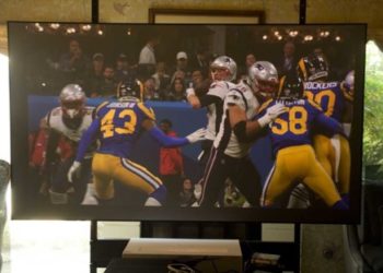 A bright vibrant sports viewing experience, in this room with large glass sliders (back left), windows (back right) skylight (above to the rear), and my football games still looked great!